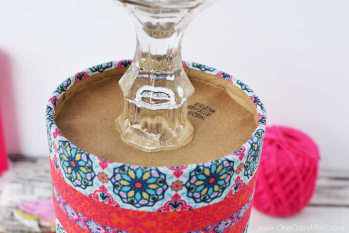 Candlestick glued on the bottom of the container.