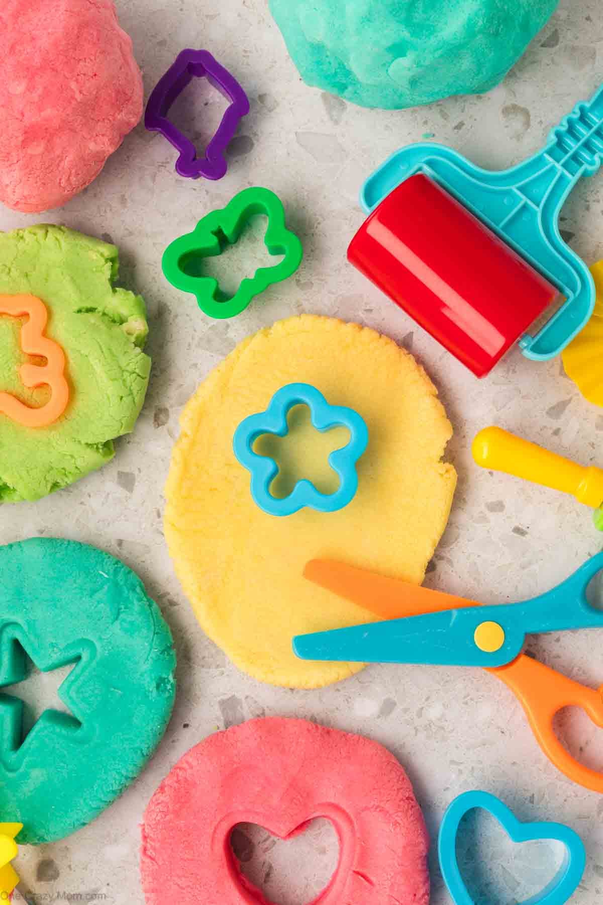 Playdough being cut in different shapes.