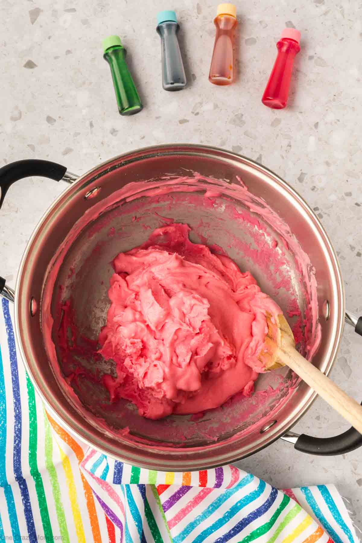 Mixture combined together in a bowl with food coloring.