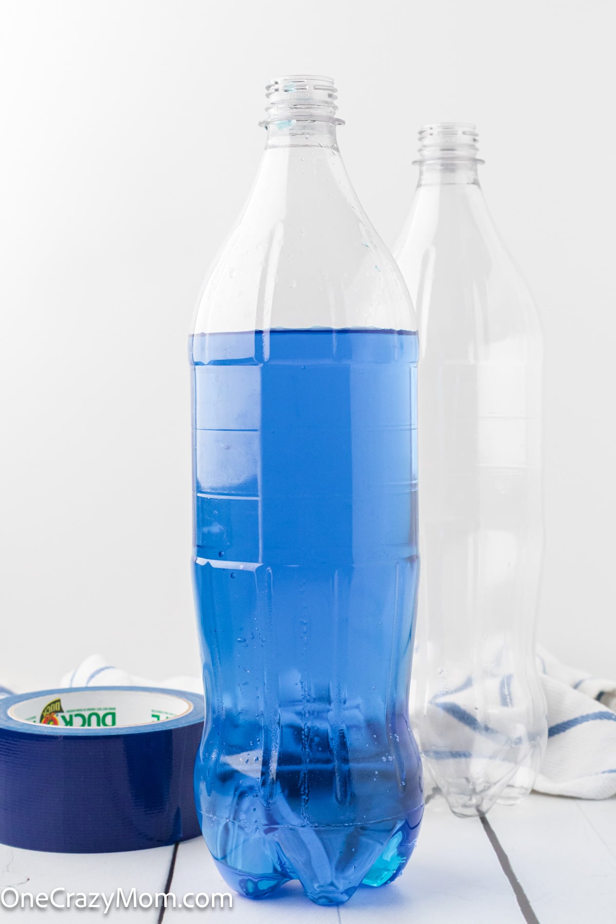 Water bottle with blue water poured in.