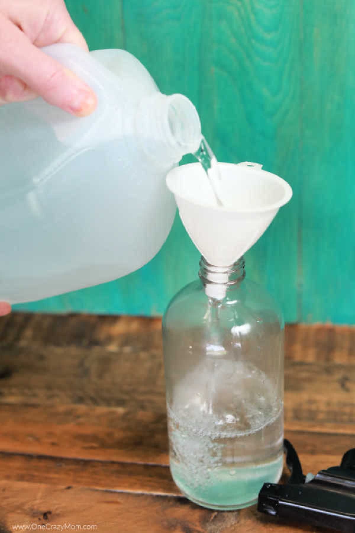 Water being poured into a bottle with funnel.