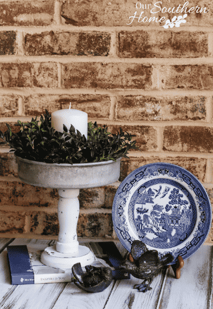 Candle holder beside a plate.