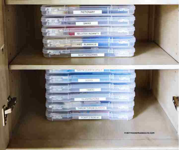 Storage containers in shelf with games.