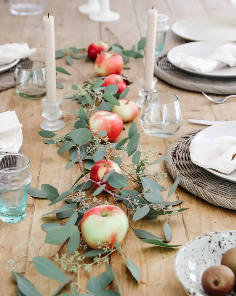 Natural table runner with apples and leaves.