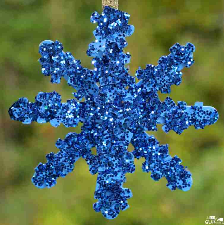 Glittery snowflake on tree.