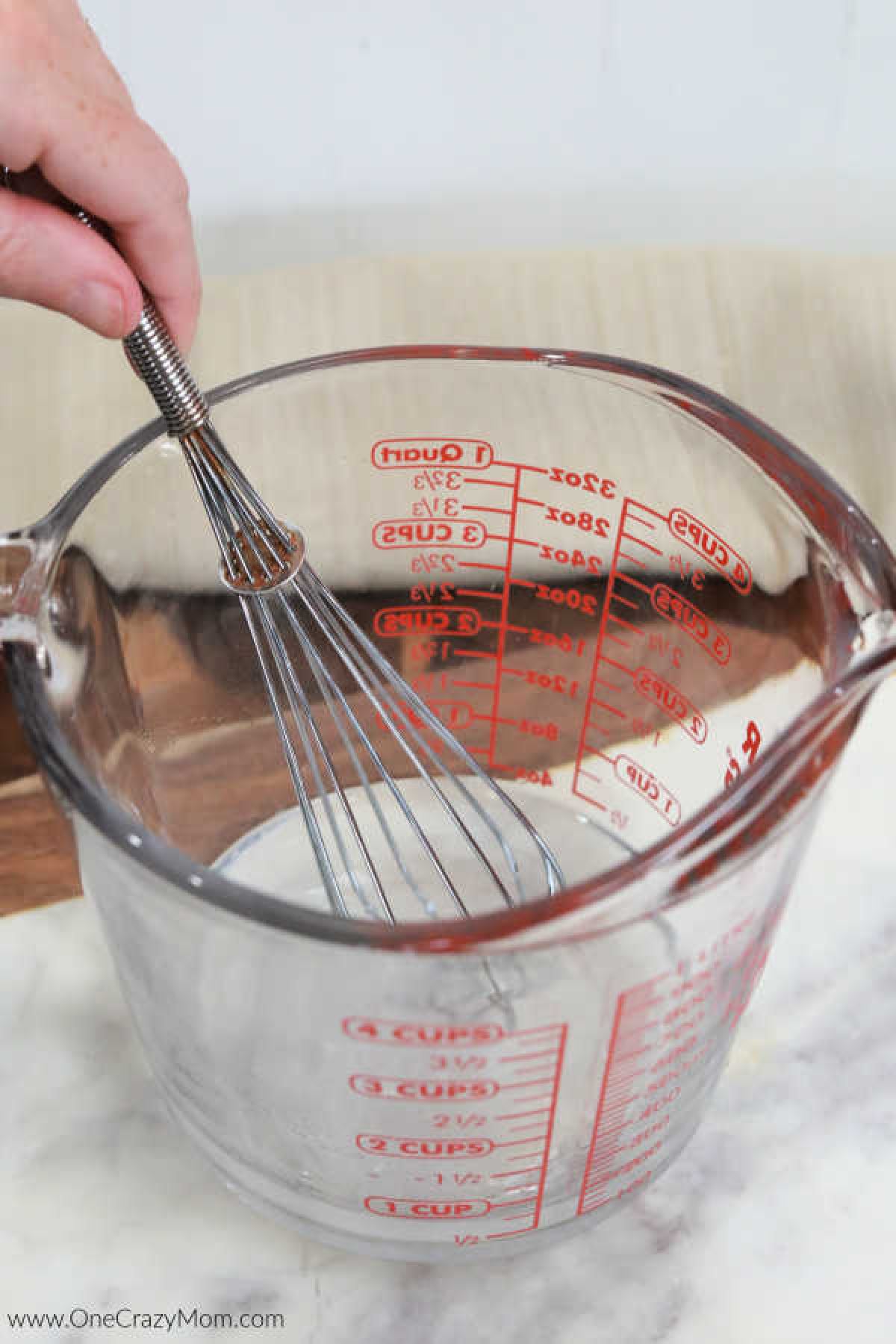 Glass measuring cup with water.
