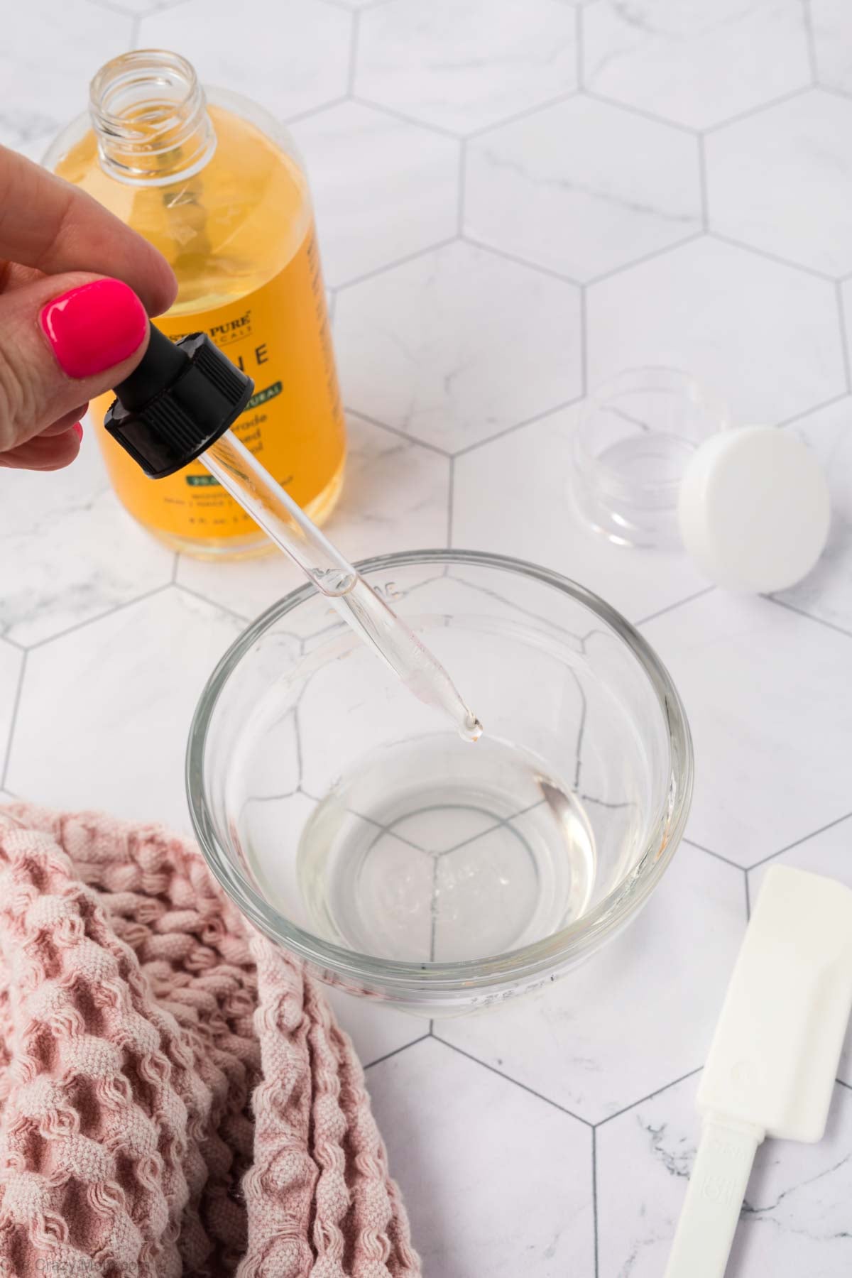 Vitamin E oil added to mixture in bowl.