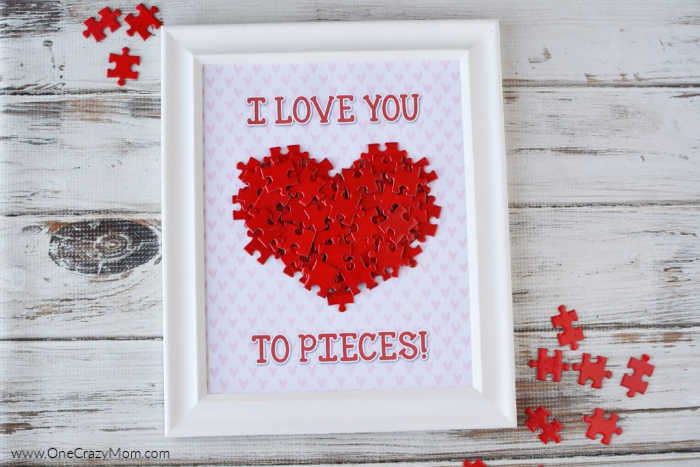 Heart made out of puzzle pieces on a frame.