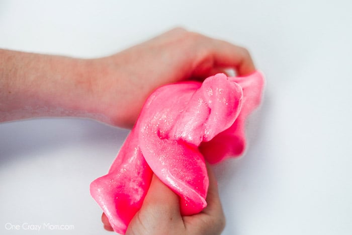 Slime in hands being pulled.