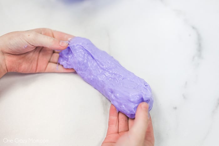 Hands kneading slime.