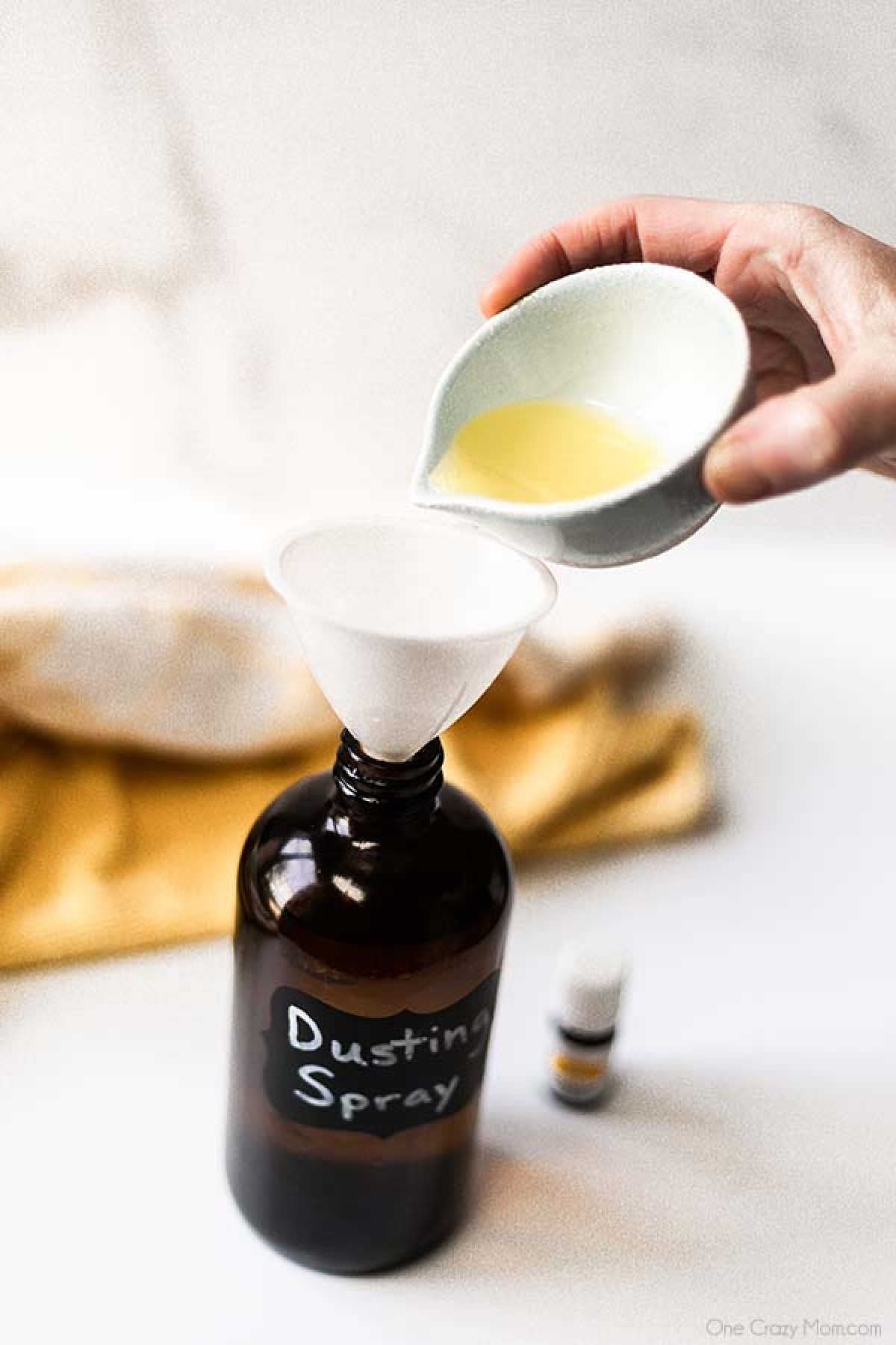 Mixture poured into spray bottle using a funnel.