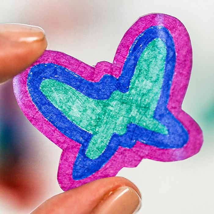 Shrinky Dink butterfly in hands.