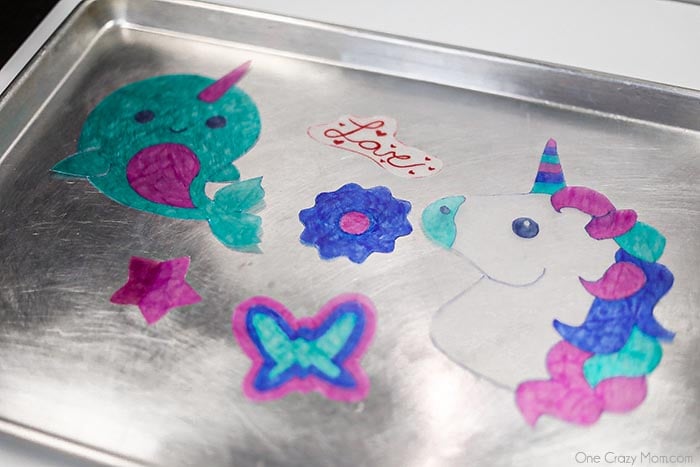 Shrinky Dinks on baking sheet ready for the oven.