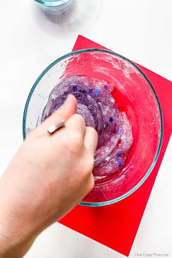 Mixture combined with a spoon.