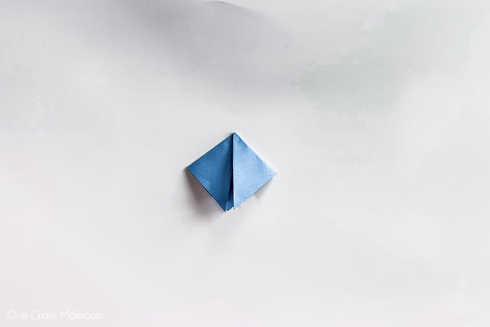 Paper folded into two triangles.