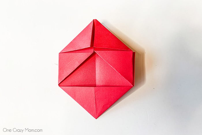 Top corners creased and folded.