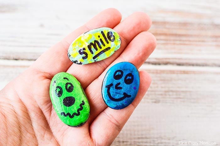 Painted rocks in hand.