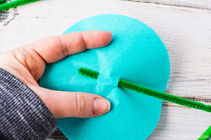Pipe Cleaner threaded through holes in circle.