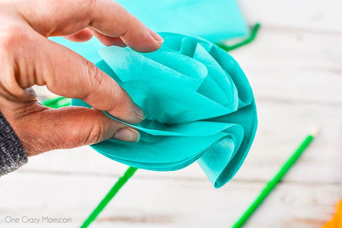 Tissue paper being separated and forming flowers.