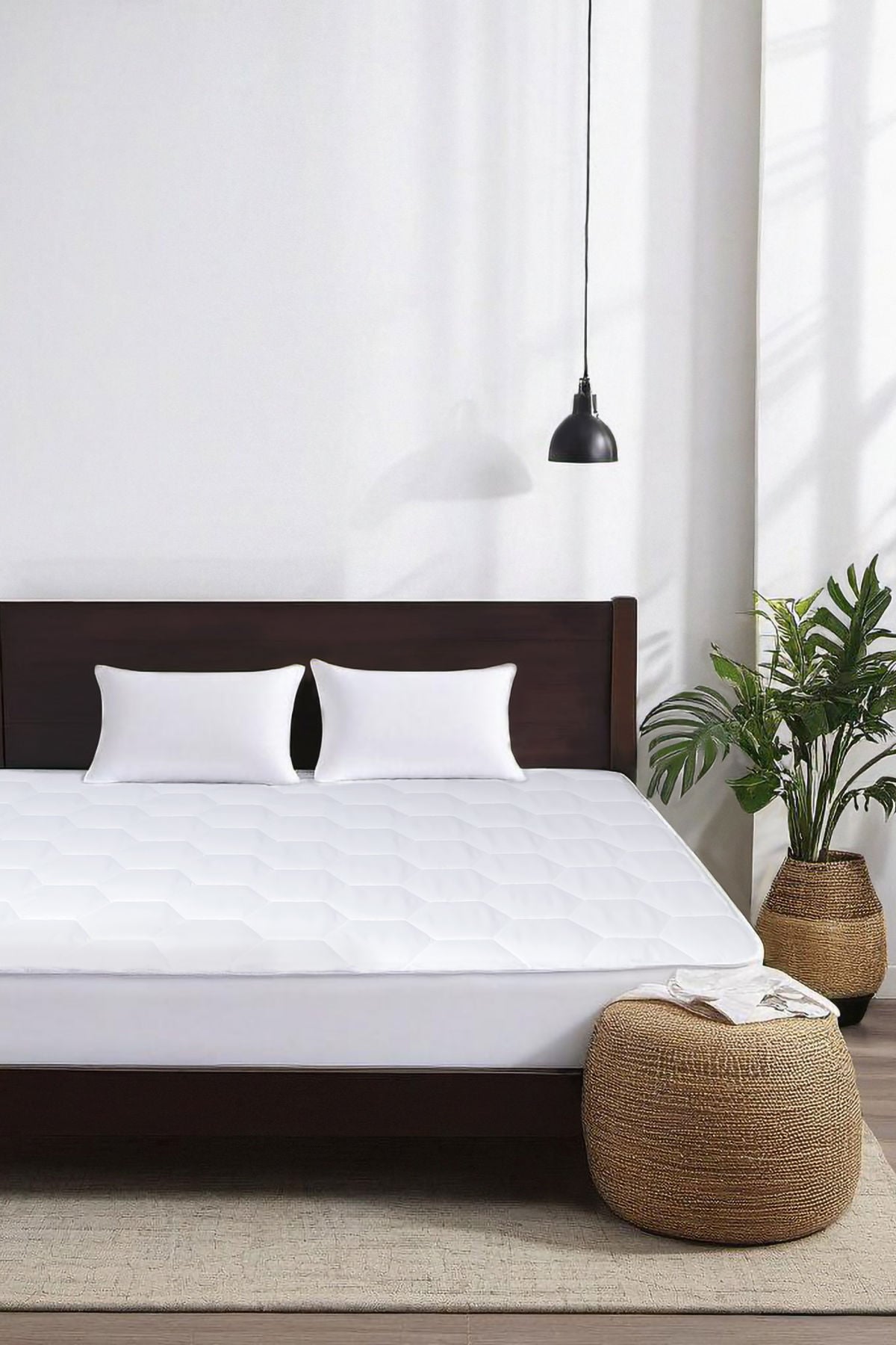 Bed with mattress pad on it.