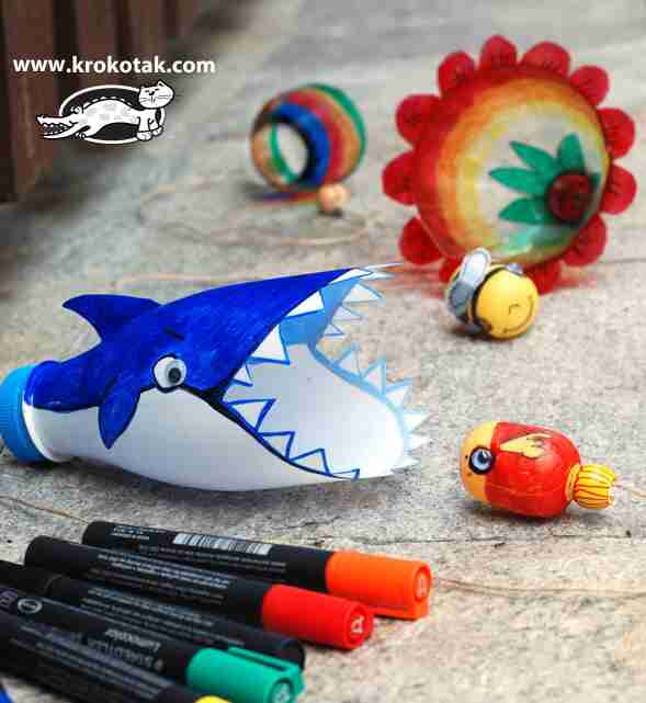 Shark plastic bottle beside markers.