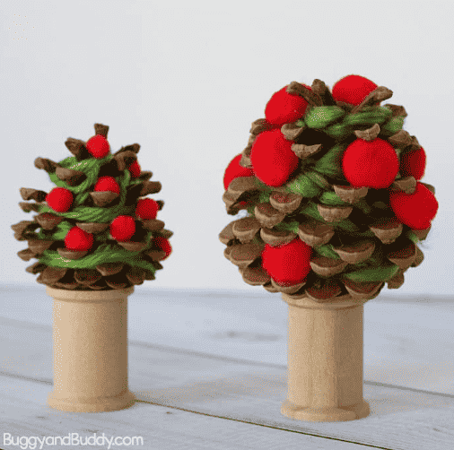 Pinecone craft with apples.