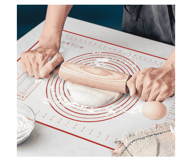 Mat with dough and rolling pin.