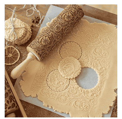 Embossed rolling pin with dough.
