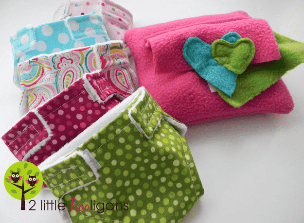 Baby doll diaper and accessories in a pile.