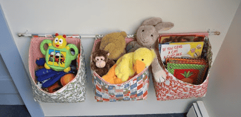 Hanging storage bins with toys.