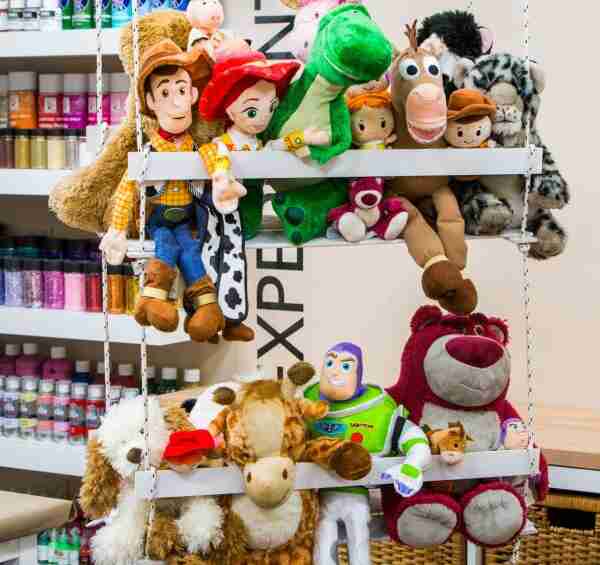 Stuffed animals in a hanging storage bin.