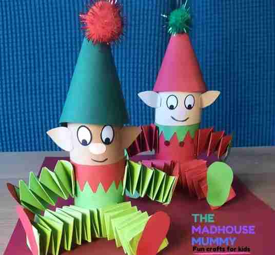 Christmas Elves sitting besides each other.