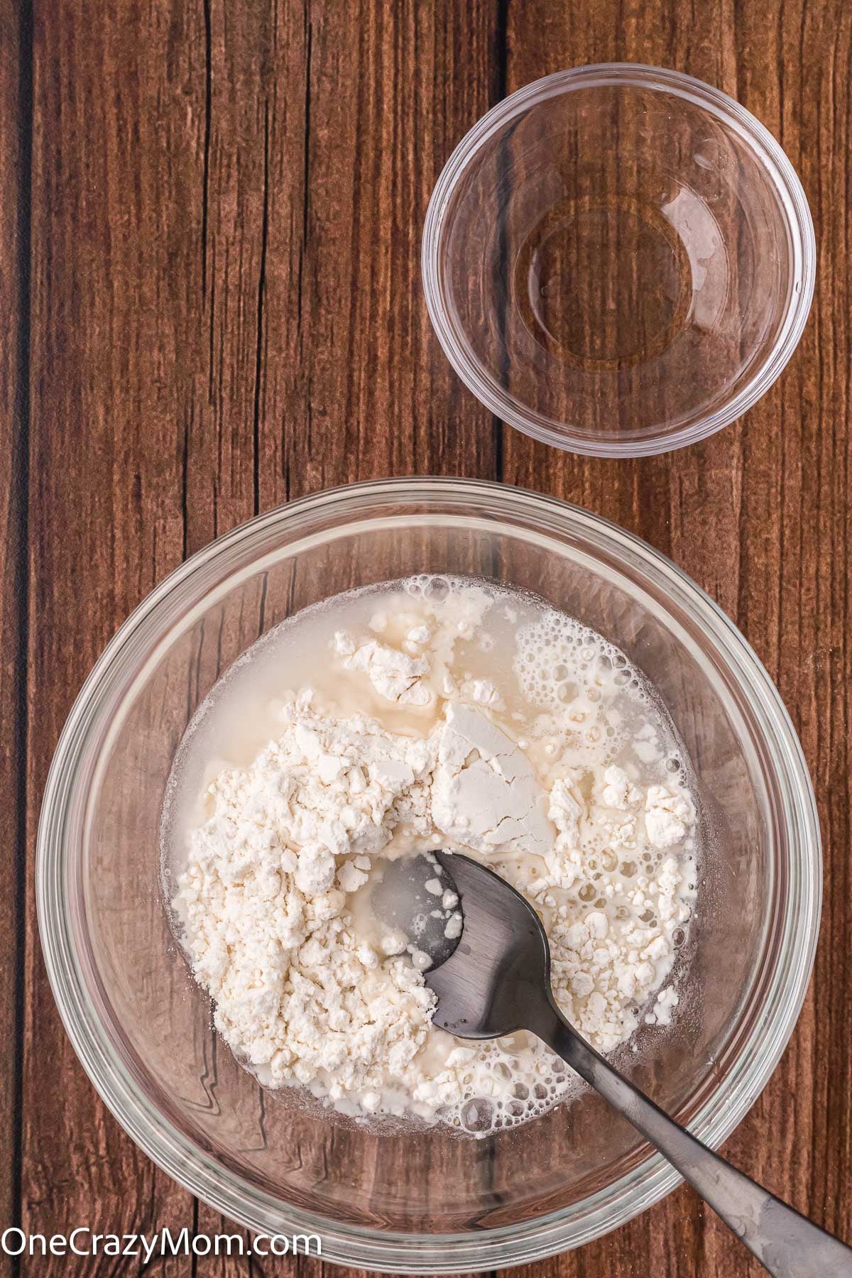 Flour and water combined in a bowl with a spoon.