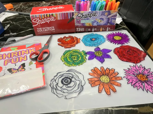 Flowers in different colors made from shrinky dinks.