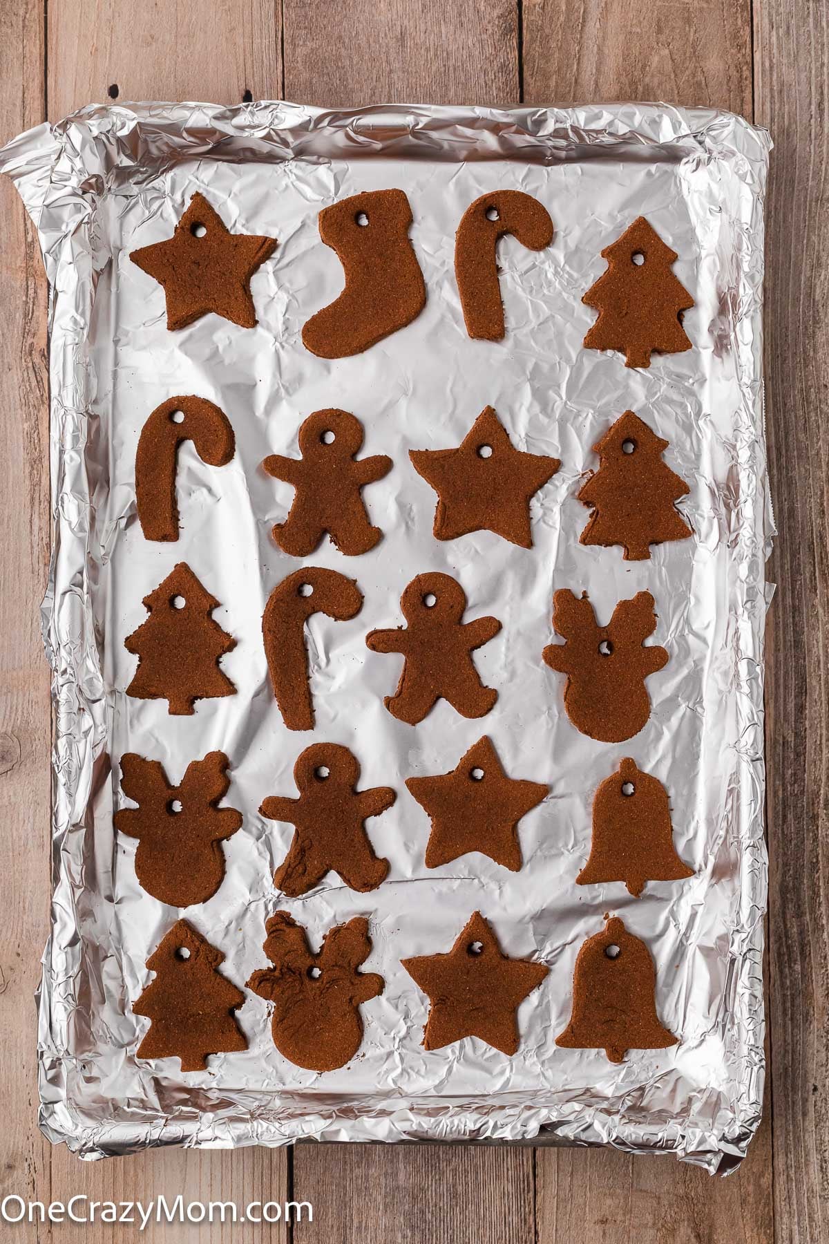 Ornaments baked and cooling on baking sheet.