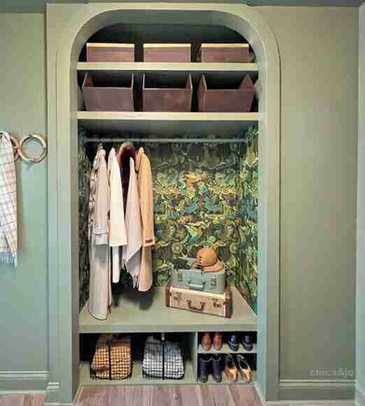 Closet with coats and shoes in open concept.