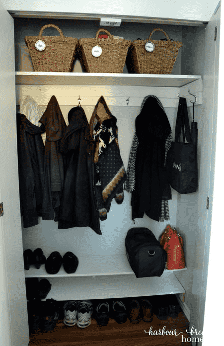 Entryway closet with shelves for shoes and purses.