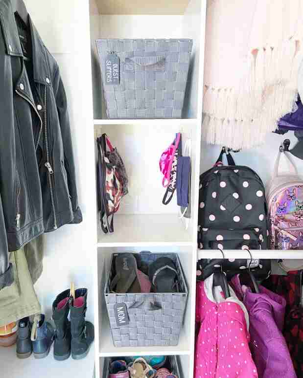 Closet with bins and cubbies.