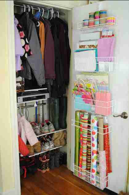 Closet door with shelving for wrapping paper and gift bags.