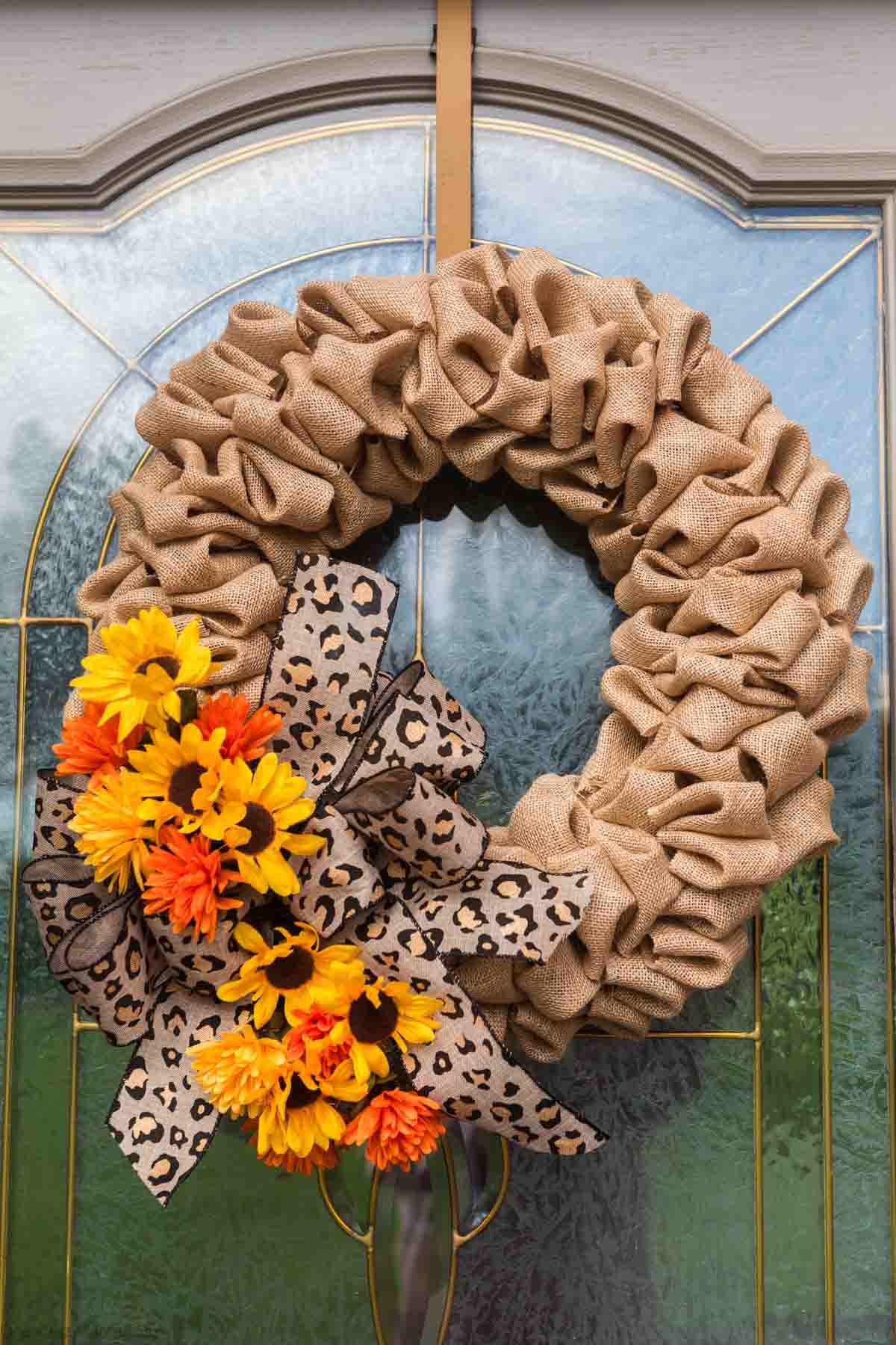 Bow, flowers and embellishments added to the wreath.