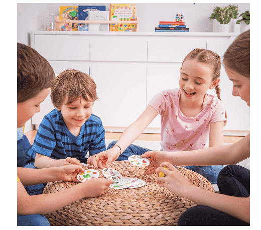 Spot it game on table with kids playing.
