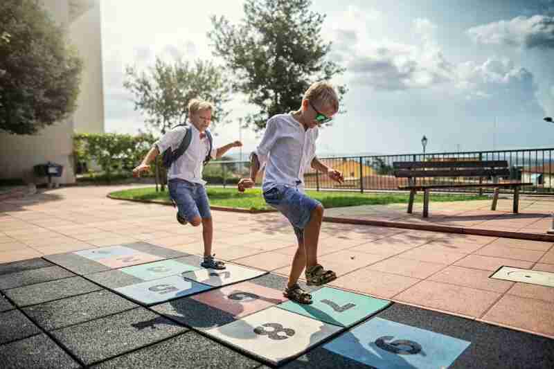 Kids playing hopscotch.
