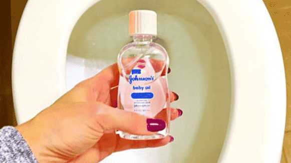 Baby oil in front of toilet.