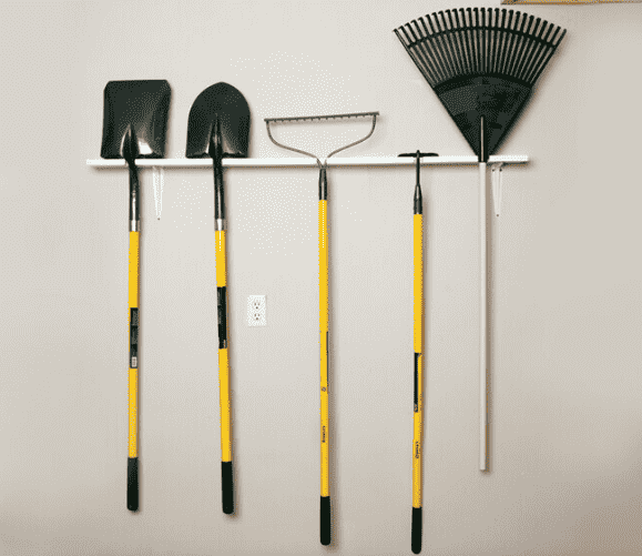 Wooden board hanging with tools.