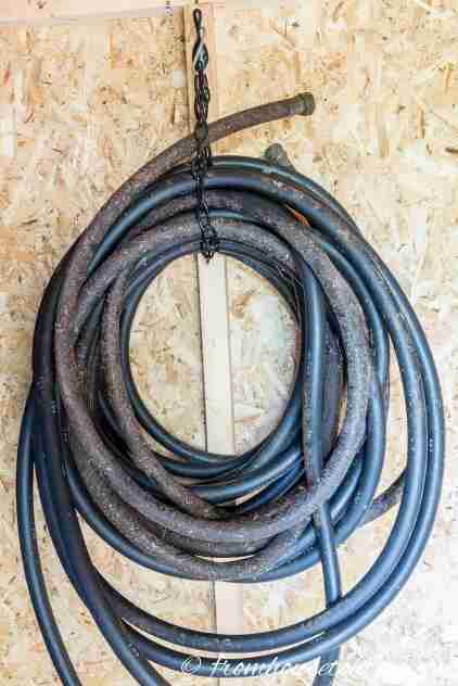 Garden hose hanging with chain.