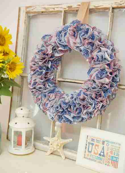 Cupcake liner wreath hanging on decor.