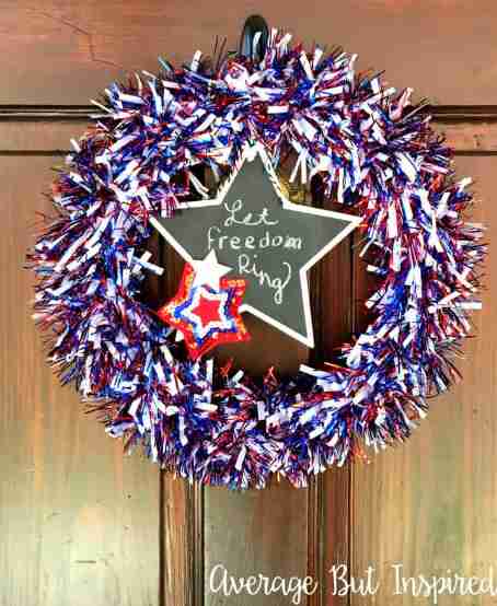 Sparkly and glitter July wreath on door with sign.