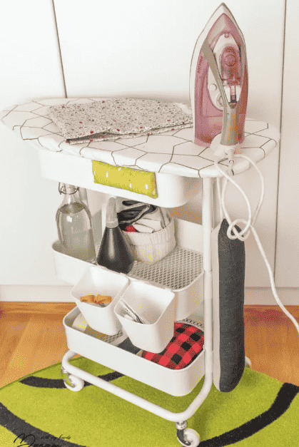 Ironing board on wheels with storage baskets.