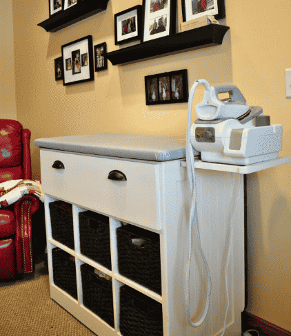 Shelving unit transformed into ironing station.