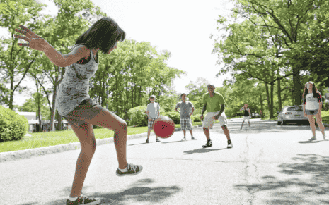 Kids and adults playing kickball.
